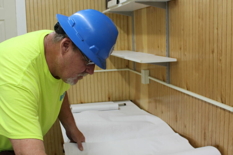 Project foreman analyzing blueprints