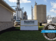 Sunrise Cooperative main office with silos and grain bins in the background. Labeled with ABC EIC Eagle Award winner.
