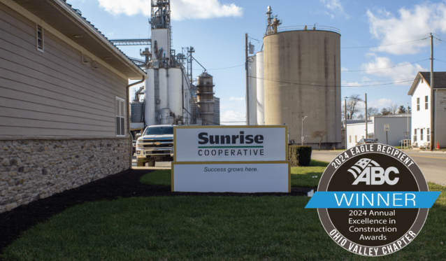 Sunrise Cooperative main office with silos and grain bins in the background. Labeled with ABC EIC Eagle Award winner.